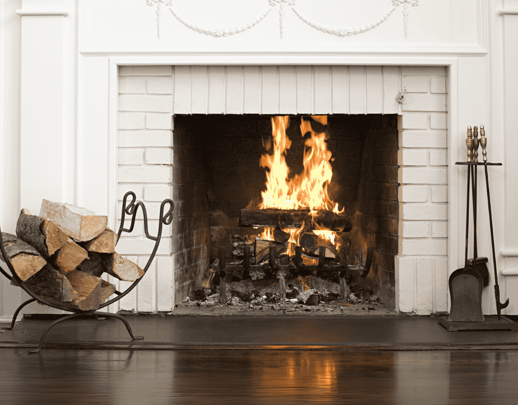 American Heritage Fireplace Milwaukee gas logs burning in classic white brick fireplace